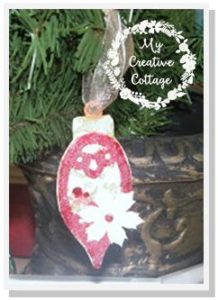 Handmade ornament using glitter and paper flowers